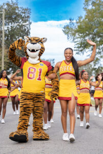 TU mascot and cheerleaders wave in the parade.